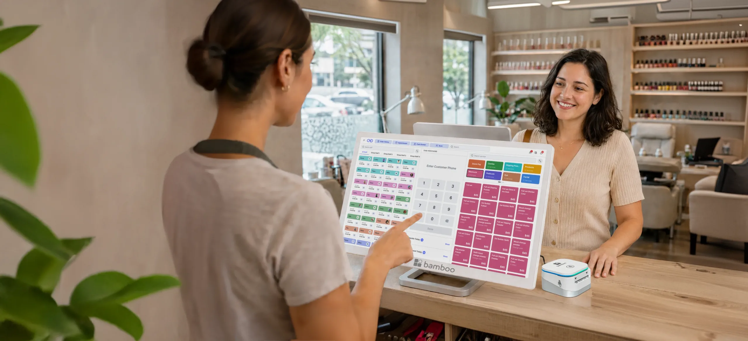 Client at a nail salon counter paying on a Go POS terminal